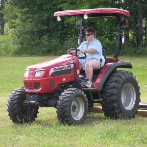 My wife Patti mowing with the Mahindra 2810 HST