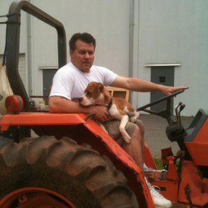 my dad and his dog on our Kubota