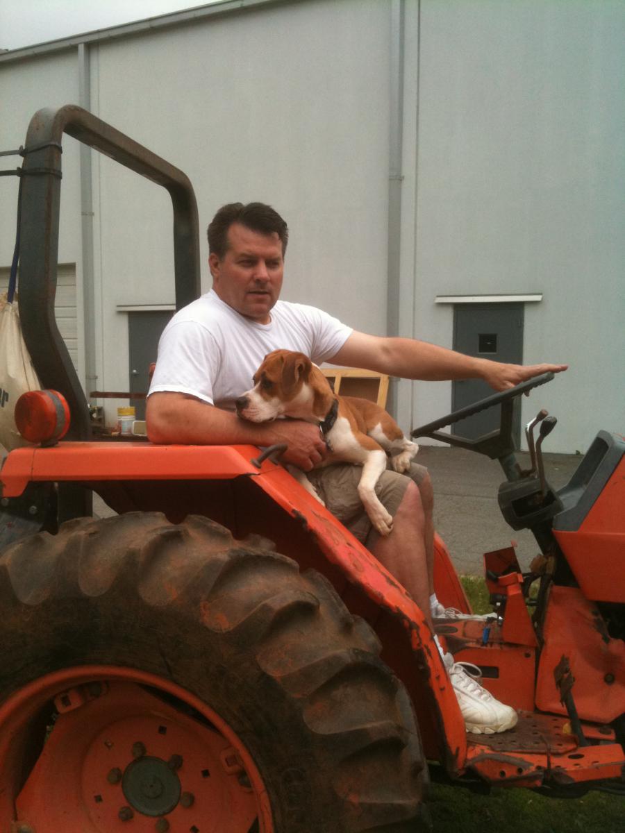 my dad and his dog on our Kubota