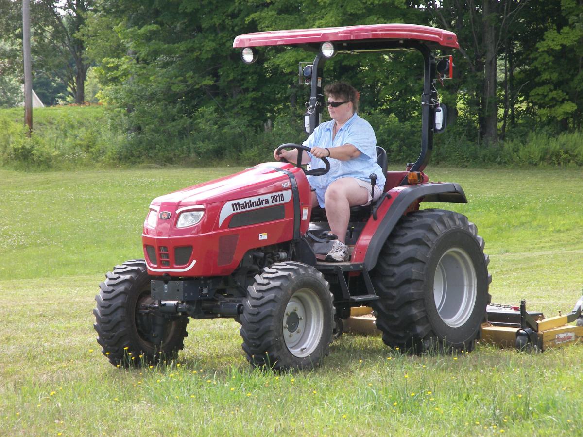 My wife Patti mowing with the Mahindra 2810 HST